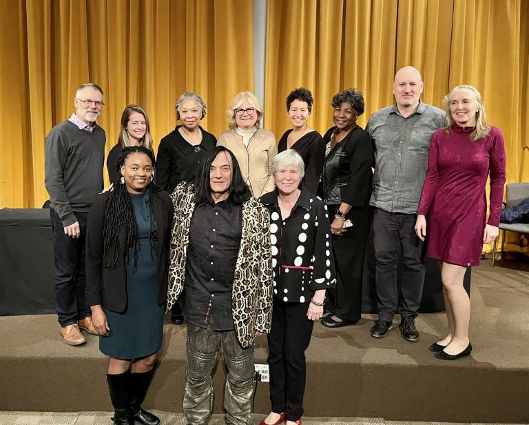 Group photo on a stage of the participants in the 2022 Minnesota Symposium