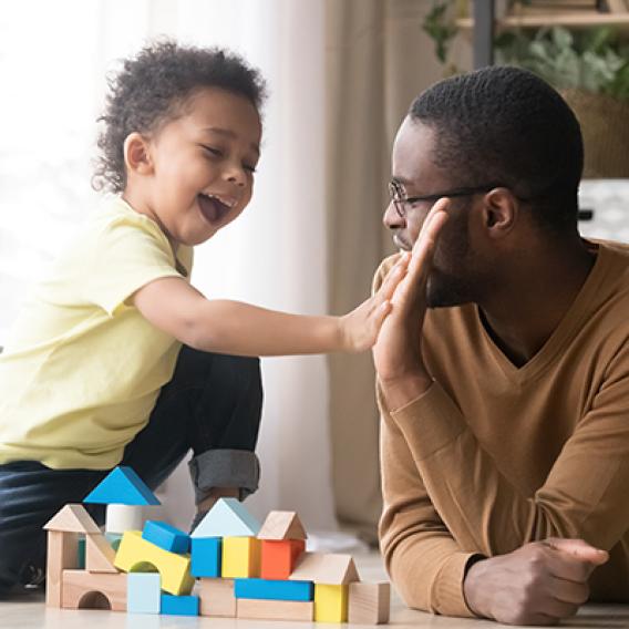 Adult giving a child a high five