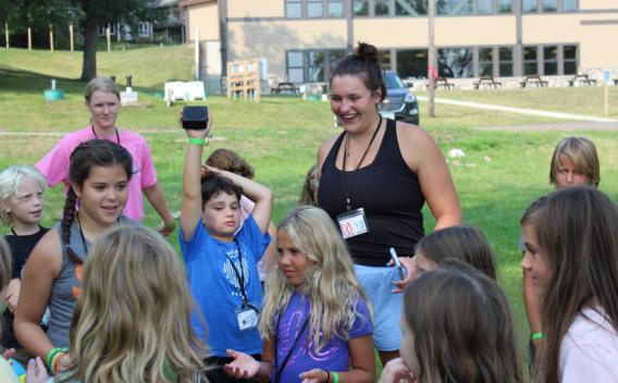 Ellie Schwartzman with a group of children outside