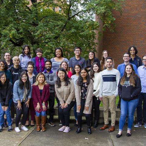 Around 30 students posed for a photo outside