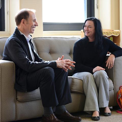 2 people meeting and sitting on a couch